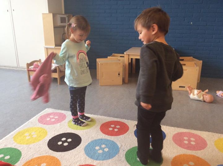 Wij spelen het spelletje 'twister' met ons vloerkleed, voetjes op blauw, – Christelijke Kinderopvang Het Paleis